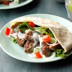 a pita filled with meat and vegetables on a plate