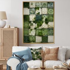 a living room with white couches and green tiles on the wall above them is a coffee table