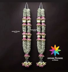 two flowered vases with flowers hanging from the side on a black background for an advertisement