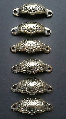 four antique style drawer pulls with ornate design