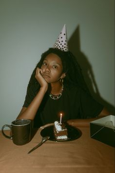 a woman sitting at a table with a piece of cake in front of her