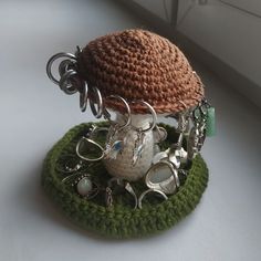 a crocheted hat with lots of charms attached to it