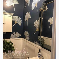 a white sink sitting under a bathroom mirror next to a wall mounted faucet