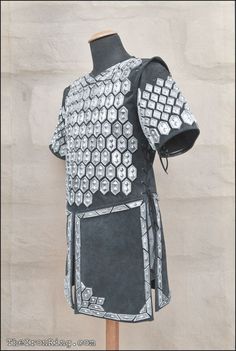 a black and white armor on display in front of a wall