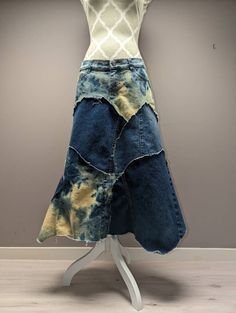 "Long upcycled bleached denim patchwork skirt with frayed seams and jagged hem. Waist measures 34\", hips 38\" and length is approximately 30\"." Fitted Cotton Denim Skirt With Unfinished Hem, Fitted Denim Skirt With Unfinished Hem, Medium Wash Cotton Skirt With Patchwork, Cotton Skirt With Patchwork In Medium Wash, Dark Wash Patchwork Cotton Skirt, Dark Wash Cotton Patchwork Skirt, Bohemian Denim Patchwork Skirt, Reworked Blue Denim Skirt, Cotton Patchwork Skirt In Dark Wash