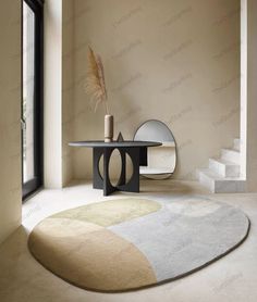 a room with a rug, table and mirror