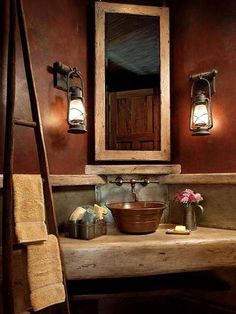 a bathroom with a sink, mirror and lights on the wall next to an old ladder