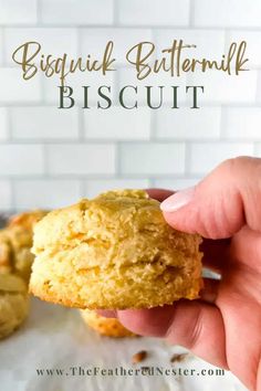 a hand holding a biscuit with the words biscuit buttermilk biscuit