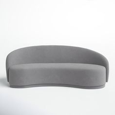 a gray couch sitting on top of a white floor