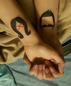 two people with matching tattoos on their arms