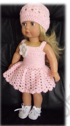 a doll wearing a pink crocheted dress and hat