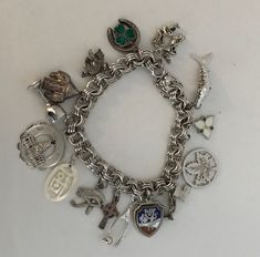 Vintage Sterling Silver Charm Bracelet Souvenir Marked 925 Fish, wishbone, luck horseshoe, Washington, Hawaii, cross, dancers and More! SEE photos for detailed description.  All items are pre-owned unless otherwise stated.  Items may show signs of wear, use, storage or age.  Please review photos or ask questions prior to checkout to ensure satisfaction with purchase. Vintage Sterling Silver Charms, Sterling Silver Charm Bracelet, Silver Charm Bracelet, Sterling Silver Charm, Charm Bracelets, Silver Charms, Vintage Sterling Silver, Hawaii, Washington