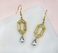 Add a touch of timeless elegance to your wardrobe with these exquisite antique gold plated geometric art deco style earrings. Featuring a stunning pear shaped aquamarine glass dangle charm, these earrings exude vintage charm and sophistication. Perfect for adding a pop of color to any outfit, these earrings are sure to become a cherished addition to your jewelry collection. Ideal for both everyday wear and special occasions, these earrings offer a unique twist on classic Art Deco style. Great Falls, Dangle Charms, Geometric Earrings, Style Earrings, Art Deco Style, Geometric Art, Deco Style, Vintage Art Deco, Vintage Charms