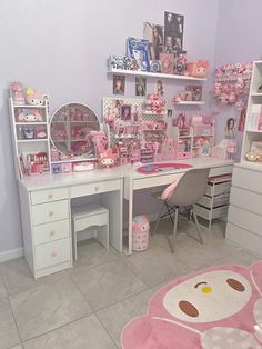 a room filled with lots of toys and decor on top of white shelves next to a pink teddy bear rug