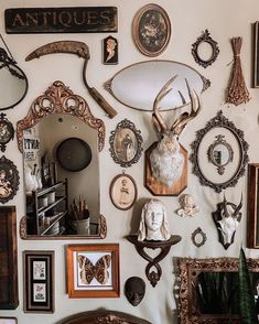 there are many antique items on the wall in this room, including an antler's head