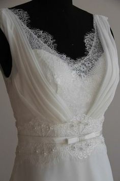 a white wedding dress on a mannequin