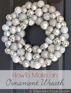 an ornament wreath with silver and white ornaments hanging from it's front door