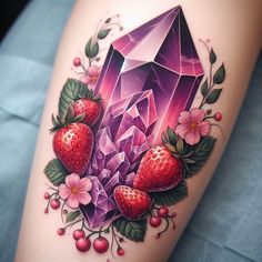 a tattoo with some fruit on it and a diamond in the middle, surrounded by flowers