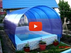 an outdoor swimming pool in the middle of a yard with potted plants and flowers