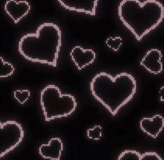 many hearts are arranged on a black background