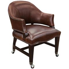 a brown leather office chair with casteors