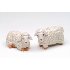 two ceramic sheep standing next to each other