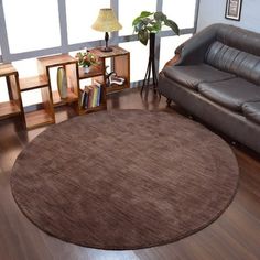 a living room with two couches and a round rug