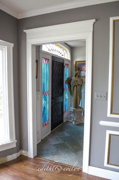 an entryway with stained glass and wood floors