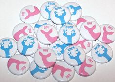 a bunch of buttons that are on top of a white table with pink and blue designs