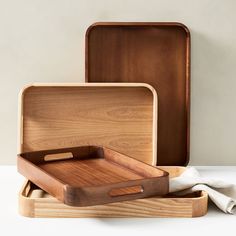 three wooden trays sitting on top of each other