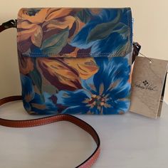 Nwt Patricia Nash Floral Leather Crossbody. Absolutely Gorgeous Crossbody. Shades Of Blue, Gold, Maroon And Green. Adjustable Leather Strap. Snap Closure. Inside Has 2 Separate Compartments W/1 Zip Compartment. Front Of Bag Has Additional Slide Compartment. Back Has Zip Compartment. Measures Approx 8” X 8”. Dust Bag Included. Blue Rectangular Flap Bag For Travel, Blue Flap Bag For Everyday Use, Blue Satchel With Detachable Strap As Gift, Everyday Use Blue Flap Bag, Blue Leather Flap Bag For Everyday Use, Blue Tote Flap Bag For Everyday Use, Blue Travel Tote Flap Bag, Blue Flap Bag With Adjustable Strap For Travel, Blue Leather Satchel As Gift