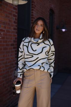 Our Oversized Abstract Sweater is the perfect blend of comfort and style. Crafted with a soft, stretchy knit and an abstract, patterned finish, this turtleneck sweater is not only unique, but provides a relaxed fit perfect for any brunch date, dinner out, or drinks with your closest friends. Trendy, versatile, and chic, you can dress it up or down, for a work look or for a casual outing. This sweater also makes a great statement piece for any wardrobe. Fabric 77% Acrylic, 22% Polyester, 4% Spand Chic White Turtleneck For Fall, Trendy Oversized Knit Turtleneck, Trendy Oversized Spring Turtleneck, Chic Oversized Turtleneck Sweater, Chic Funnel Neck Turtleneck For Fall, Trendy Oversized Soft Knit Turtleneck, Chic Textured Knit Sweater With Funnel Neck, Chic Textured Knit Funnel Neck Sweater, Chic Oversized High Neck Turtleneck