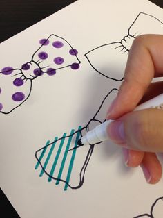 a person is drawing on paper with markers