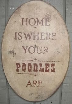 a sign that says home is where your poodles are