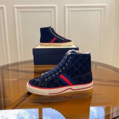 A high-top sneaker in dark blue suede. The style combines different elements from the House's heritage such as the Gucci Tennis 1977 label, a textured GG motif at the sole and the House Web—details which recall the House's connection to the world of sports and leisure. dark blue suede Men's Blue and red Web Gucci Tennis 1977 label GG motif at the sole 5" boot shaft height, measurements based on a size 43 (IT) .8" height Made in Italy Designer Bags Louis Vuitton, Web Detail, Red Web, Tote Outfit, Burberry Sunglasses, World Of Sports, Wallet Accessories, Leather Hobo, Blue Suede