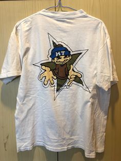 Onieta tag 90s hip hop graffiti hype thread rap vtg tees t shirt white M : 100% authentic product : size ( tag L fits more M ) Made In USA : armpit to armpit = 22.5" : total length= 26" : condition = (USED) great condition ALL OFFER WILL BE CONSIDER PLEASE CONTACT .PAYMENT & SHIPPING. : FOR PAYMENT WE ONLY ACCEPT PAYMENT VIA PAYPAL. : PLEASE MAKE THE PAYMENT WITHIN 7DAYS AFTER THE TRANSACTION ENDS. :   DELIVERY TIME SHOULD BE AROUND 8-25DAYS DEPENDING ON YOUR WORLDZONE, :  ITEM WILL BE SEND OUT TO WORLDWIDE FROM THAILAND VIA THAILAND REGISTERED INTERNATIONAL AIRMAIL WITH TRACKING NUMBER. : DISCOUNT FOR COMBINE POSTAGE IS  -USD FOR THE FISRT ITEM AND -USD FOR AN EACH ADDTIONAL ITEM,SO IF YOU ARE WIN MORE THAN ONE ITEM PLEASE WAIT FOR YOUR NEW TOTAL INVOICE WITH DISCOUNT BEFORE MAKE THE PAYM Casual Graffiti Print Fan Merchandise T-shirt, Casual Graffiti Print T-shirt For Fan Merchandise, White Graphic Print T-shirt For Skateboarding, Casual Graffiti Print T-shirt For Fans, White Retro T-shirt With Graffiti Print, Graphic Tee T-shirt With Graffiti Print For Skateboarding, 90s White Fan Merchandise T-shirt, 90s Style Pre-shrunk White T-shirt, Vintage White T-shirt With Graffiti Print