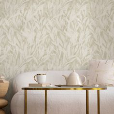 a white couch sitting next to a table on top of a wooden floor