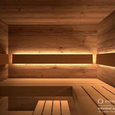 an empty sauna with wooden benches and lighting