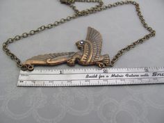 "Vintage Art Nouveau design Egyptian Revival Bird Pendant Necklace. A fabulous Horus falcon design, with a tiny sparkling rhinestone accent. Beautiful Antiqued brass. Ornate detailed bird, 2-1/8\" across. Antiqued brass finish brass chain with a lobster clasp. Sent to you with Aloha! #91 More of my Artisan Jewelry: hawaiibeads.etsy.com" Bronze Metal Fantasy Necklace, Fantasy Metal Necklaces For Collectors, Fantasy Style Bronze Metal Necklace, Fantasy Gold Necklace For Cosplay, Adjustable Fantasy Necklaces For Cosplay, Handmade Metal Necklace For Cosplay, Fantasy Style Gold Necklace For Cosplay, Adjustable Fantasy Necklace For Cosplay, Handmade Metal Necklaces For Cosplay