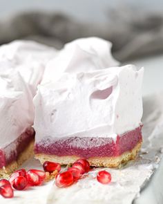 there is a piece of cake with white frosting and pomegranates on it