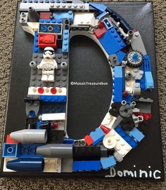 the letter o made out of legos is shown in front of a carpeted floor