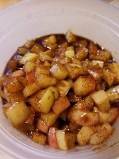 a white bowl filled with food on top of a table