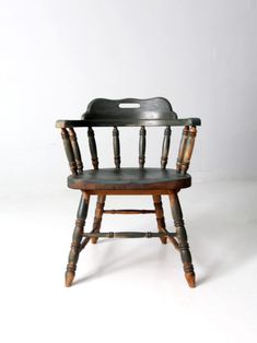 an old wooden chair sitting on top of a white floor