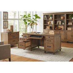 a wooden desk sitting in front of a window