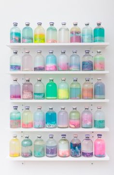 there are many different colored bottles on the shelves in this room and one is filled with soap