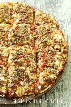 a pizza sitting on top of a wooden cutting board