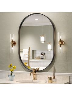 a bathroom with a large round mirror above the sink and yellow flowers on the counter