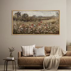 a living room filled with furniture and a painting hanging on the wall above it's headboard