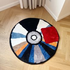 a colorful rug on the floor next to a radiator