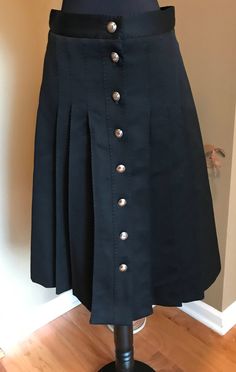 "Description *Black double knit A-line skirt with silver buttons down front center. *Knee length, fully lined *This listing is only for the skirt Material  No label, feels like polyester. Condition  Excellent condition.   Size Vintage S, Modern Day S Measurements (taken lying flat, unstretched; double for accuracy):    Waist: 13.5\"/ 34.2 cm  Hips: 19\"/ 48.2 cm Length: 25\" /63.5 cm Label History No label. On Instagram? Follow me for updates on the latest vintage additions https://www.instagram.com/smokeypearlvintage/  All vintage garments will show general signs of wear consistent with its age and use." Long Lace Skirt, Vintage Pleated Skirt, Black Lace Skirt, Black Pleated Skirt, No Label, Double Knit, Beautiful Skirts, Silver Buttons, Modern Dress